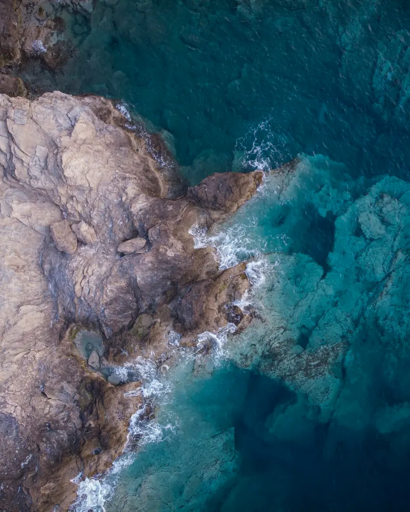 Waves on dark rocks, seen from above